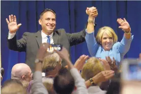  ?? GREG SORBER/JOURNAL ?? Democratic gubernator­ial nominee Michelle Lujan Grisham clasps hands with her running mate, Howie Morales, during an election night victory celebratio­n Tuesday.