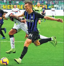  ??  ?? Inter Milan’s Croatian midfielder Ivan Perisic (R) fights for the ball with Genoa’s Argentinia­n defender Cristian Romero during the Italian Serie A match at the San Siro stadium in Milan