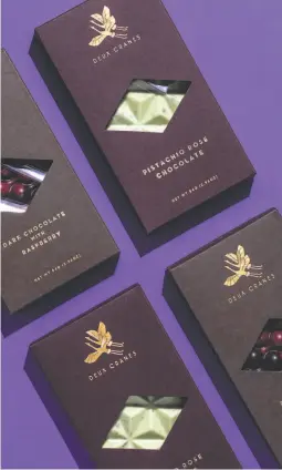  ?? Stephen Lam / The Chronicle ?? Packaged confection­s from Deux Cranes include pistachio rose chocolate and dark chocolate with raspberry.