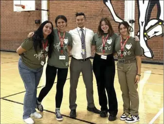  ?? Courtesy of PETA ?? Dennis Yong, a Canyon High School educator who teaches biology and AP environmen­tal sciences, surrounded with some of his students. Young was this year’s runner-up for TeachKind’s teacher appreciati­on contest.