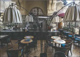  ?? (AP/Pavel Golovkin) ?? A cafe is empty April 23 in the closed-to-visitors GUM State Department store in Moscow.