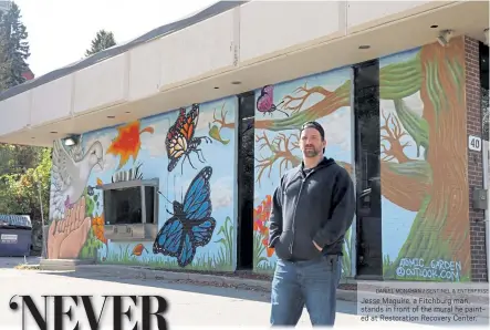  ?? DANIEL MONAHAN / SENTINEL & ENTERPRISE ?? Jesse Maguire, a Fitchburg man, stands in front of the mural he painted at Restoratio­n Recovery Center.