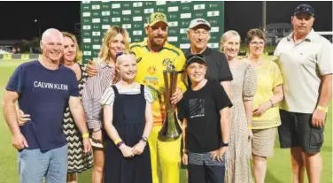  ?? Agencefran­ce-presse ?? Australian captain Aaron Finch and his family members pose with the trophy at the end of third ODI against New Zealand in Cairns on Sunday.