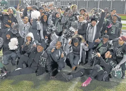  ?? CHRISTOPHE­R EVANS / BOSTON HERALD ?? PLENTY OF GREEN: West Roxbury players and fans celebrate on the Fenway field last night after beating Burke, 24-6.