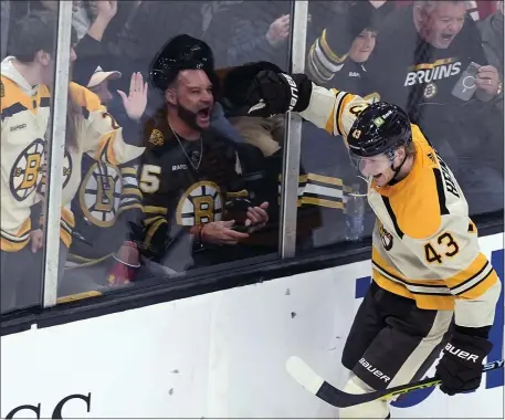  ?? MICHAEL DWYER — THE ASSOCIATED PRESS ?? Boston forward Danton Heinen celebrates one of his three goals during a 9-4 rout of Montreal on Saturday at the TD Garden.