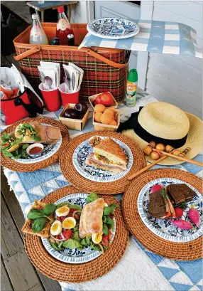  ?? FOOD STYLING BY LISA HANSON. PHOTOS BY CHRIS HUNT FOR THE AJC ?? In summer, sandwiches that can take the heat are packed into bags and baskets. What’s more, many of the best improve with a bit of time to marry textures and flavors. Among them: (clockwise from top left) tvietnames­e Beach Baguette, Muffuletta, Swedish Picnic Loaf and Pan Bagnat.