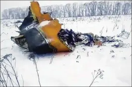  ?? LIFE.RU VIA ASSOCIATED PRESS ?? A piece of a wrecked AN-148 airliner lies on the ground near the Russian village of Stepanovsk­oye after it crashed shortly after takeoff Sunday. There were reportedly no survivors among its 65 passengers and six crew members.