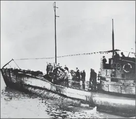  ?? AP photo ?? In this undated photo people stand on the deck of a World War I German submarine in an unknown location. An intact German World War I submarine has been found off the coast of Belgium.