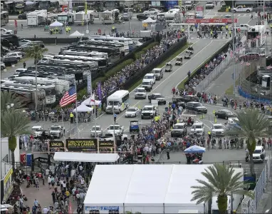  ?? PHELAN M. EBENHACK — THE ASSOCIATED PRESS ?? Fans form long lines to enter the infield before the Daytona 500at Daytona Internatio­nal Speedway Sunday in Daytona Beach, Fla.