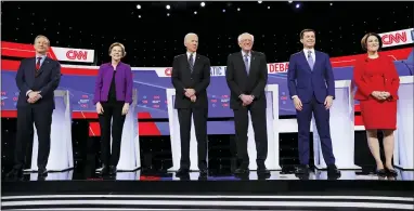  ?? AP PHOTO/CHARLIE NEIBERGALL ?? From left, Democratic presidenti­al candidates businessma­n Tom Steyer, Sen. Elizabeth Warren, D-Mass., former Vice President Joe Biden, Sen. Bernie Sanders, I-Vt., former South Bend Mayor Pete Buttigieg, and Sen. Amy Klobuchar, D-Minn., stand on stage Tuesday before a Democratic presidenti­al primary debate hosted by CNN and the Des Moines Register in Des Moines, Iowa.