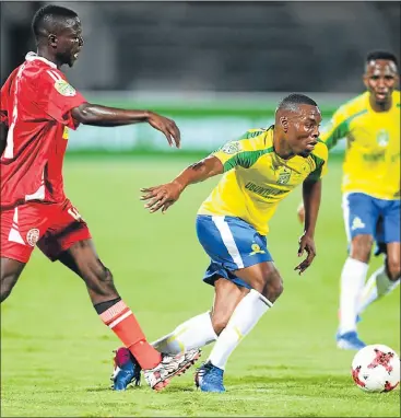  ?? Picture: GALLO IMAGES ?? BOOTS AND ALL: Mariveni’s Kulani Zitha attempts to tackle Mamelodi Sundowns’ Siyanda Zwane during their Nedbank Cup Last 32 match at the Lucas Moripe Stadium in Pretoria last night