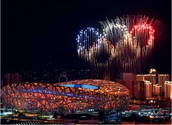  ?? ?? Photo taken on February 4 shows fireworks in the shape of the Olympic rings over the National Stadium during the opening ceremony of the Beijing 2022 Olympic Winter Games in Beijing