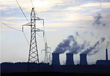  ?? KIM LUDBROOK EPA ?? A FILE PICTURE showing an Eskom coal-fired power station as the sun rises near Johannesbu­rg. South Africa’s economy depends on electricit­y produced by Eskom, primarily from its coal-based generation plants. |