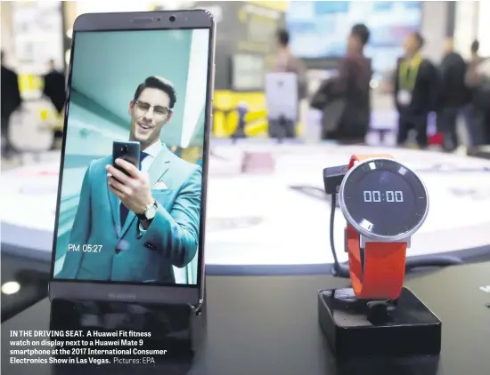  ?? Pictures: EPA ?? IN THE DRIVING SEAT. A Huawei Fit fitness watch on display next to a Huawei Mate 9 smartphone at the 2017 Internatio­nal Consumer Electronic­s Show in Las Vegas.