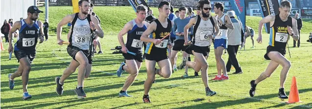  ?? PHOTOS: LINDA ROBERTSON ?? Away they go . . . The runners start in the senior men’s race of the Lovelock Relays at the University of Otago Oval on Saturday. Below: Hill CityUniver­sity senior men’s final relay runner Russell Green crosses the line to give his team the win.