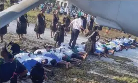  ?? Photograph: Facebook ?? Chinese ambassador Tang Songgen walks on the backs of young men, part of a welcoming gesture on Marakei island in Kiribati.