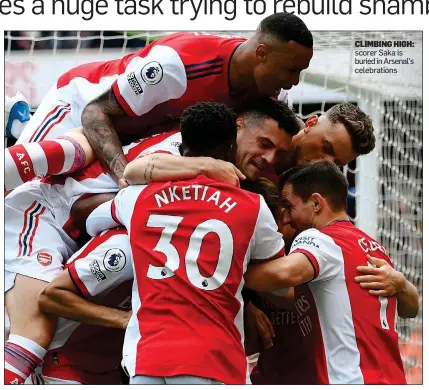  ?? ?? CLIMBING HIGH: scorer Saka is buried in Arsenal’s celebratio­ns