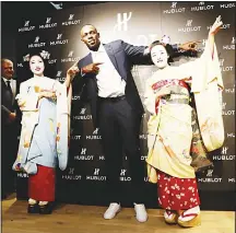  ??  ?? Retired Jamaican sprinter Usain Bolt (center), poses with Japanese maikos (apprentice geishas) during a charity event in Kyoto on Sept 5. (AFP)