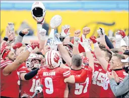  ?? JEFF SINER/AP ?? Wisconsin players hoist the trophy following victory over Wake Forest in the Duke's Mayo Bowl NCAA at Bank of America Stadium in Charlotte, N.C., on Wednesday.
