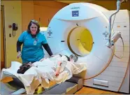  ?? SARAH GORDON/THE DAY ?? Doreen Keefe, a CT scan specialist, talks with patient Fiona Keenan of Niantic before a CT scan of Keenan’s lungs Tuesday at L+M Diagnostic Imaging in Waterford. Dr. Louis Mazzarelli is working with the low-dose CT scan to detect lung cancer in high-risk patients who exhibit no symptoms, with the intention of detecting the disease early.