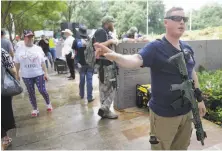  ?? Melissa Phillip / Houston Chronicle ?? Members of the Texas Patriot Network and other people carry weapons as they protest outside the Islamic Society of North America convention in Houston.