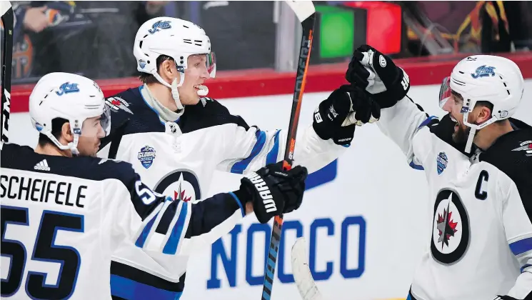  ?? — THE ASSOCIATED PRESS FILES ?? From left, Mark Scheifele, Patrik Laine and Blake Wheeler of the Winnipeg Jets. Scheifele and Wheeler were named Central Division all-stars.