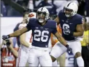  ?? MICHAEL CONROY — THE ASSOCIATED PRESS FILE ?? Penn State’s Saquon Barkley (26) is congratula­ted by teammate Andre Robinson after catching an 18-yard pass for a touchdown during the second half of the Big Ten championsh­ip NCAA college football game against Wisconsin, in Indianapol­is.