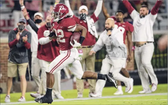  ?? Mickey Welsh / Associated Press ?? Najee Harris races for a 39-yard touchdown run late in the third quarter during Alabama’s 42-13 rout of Auburn in the Iron Bowl at Tuscaloosa, Ala.