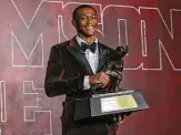  ?? Kent Gidney / Associated Press ?? Alabama wide receiver Devonta Smith bested three quarterbac­ks to hoist the Heisman Trophy.