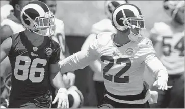  ?? Mark J. Terrill Associated Press ?? CORNERBACK TRUMAINE JOHNSON (22) covers receiver Nelson Spruce during a Rams practice Monday after being absent from the organized team activity workouts for a week.