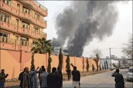  ?? ASSOCIATED PRESS ?? Smoke rises Wednesday in Jalalabad, Afghanista­n, after a deadly suicide attack on the offices of the aid group Save the Children. Five people, including three aid workers, were killed, as were the five assailants, during the 10-hour siege.