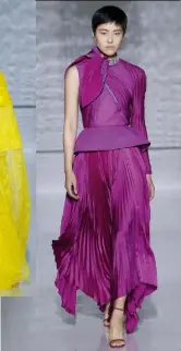  ??  ?? The Ultra-violet: Jung Sohyun models this pleated one-sleeve dress in silk satin and silk taffeta, topped off with a twisted scarf at the neck and a glittering crystal-embellishe­d choker in silver-finished metal. The organdie bodice and basque takes up to a day to sew.