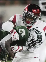  ?? NWA Democrat-Gazette/CHARLIE KAIJO ?? Arkansas defensive back Santos Ramirez tackles Colorado State receiver Preston Williams during the third quarter of Saturday’s loss. Ramirez had 10 tackles — the second-highest total on the team — including four solo tackles.