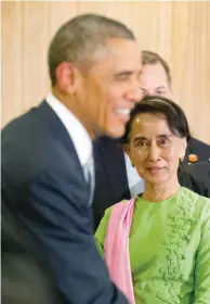  ??  ?? OBAMA MEETS SUU KYI –Myanmar’s opposition leader Aung San Suu Kyi ( right) looks on as U. S. President Barack Obama greets other participan­ts following a meeting at Parliament­ary Resource Center in Naypyitaw on Friday. (AP)