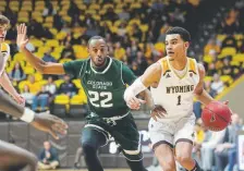  ?? Jacob Richard Byk, The Associated Press via The Wyoming Tribune Eagle ?? Wyoming guard Justin James drives against Colorado State guard J.D. Paige on Saturday in Laramie. James scored a career-high 36 points.