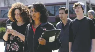  ??  ?? Workers exit the YouTube complex in San Bruno, Calif., on Tuesday. A woman opened fire at YouTube headquarte­rs, setting off a panic among employees and wounding several people before fatally shooting herself, police and witnesses said.