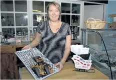  ?? MICHELLE ALLENBERG/WELLAND TRIBUNE ?? Owner of the Vegan Hippie Chick, Mandy McCullough holds a tray of peanut butter chocolate brownies at her newly opened restaurant on East Main Street in Welland.