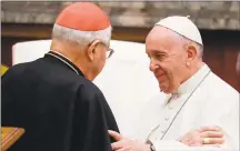  ?? Andrew Medichini / Pool/AFP via Getty Images ?? Pope Francis, right, and Cardinal Angelo Sodano greet on the occasion of the pontiff ’s Christmas greetings to the Roman Curia, in the Clementine Hall at the Vatican on Saturday.