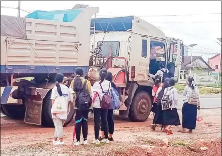  ?? SUPPLIED ?? Students boarding a truck on the side of the road in Kampong Seila district of Preah Sihanouk province.