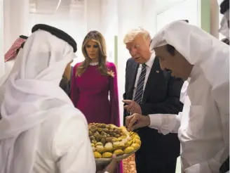  ?? Anadolu Agency / Getty Images ?? First lady Melania Trump and President Trump (center) attend a dinner in their honor hosted by Saudi Arabia’s King Salman (right) at Murabba Palace in Riyadh, Saudi Arabia.