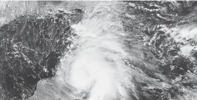  ?? HANDOUT / NOAA / RAMMB / AFP / GETTY IMAGES ?? A satellite image taken Monday shows Hurricane Michael off the U.S. Gulf Coast. On Tuesday, it was rapidly picking up steam in the Gulf of Mexico as coastal residents rushed to board up their homes and sandbag their properties.