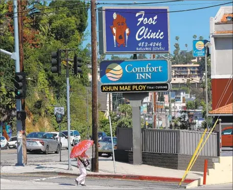  ?? Gary Coronado Los Angeles Times ?? NOT TO JINX your day, but here’s a glimpse of the Sad Foot side of the Rampart Village-bound Sunset Foot Clinic sign in Silver Lake.