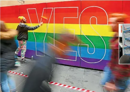  ?? REUTERS, GETTY IMAGES ?? Marriage equality’s yes campaign has been loud, proud and colourful throughout Australia, but those working the phones to convince people to vote, below, have sometimes struggled with how divisive the issue has been.