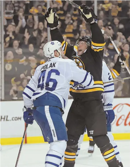  ?? STAFF PHOTO BY MATT STONE ?? START OF SOMETHING GOOD: Jake DeBrusk celebrates in front of the Maple Leafs’ Roman Polak after scoring the first of his two goals in the Bruins’ 7-4 clinching victory in last night’s Game 7 at the Garden.