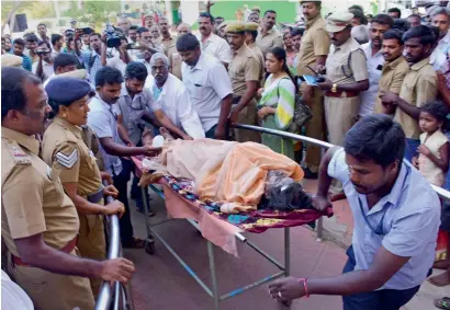  ?? PTI ?? An injured trekker who was caught in the forest fire being brought to the Government Medical College Hospital in Theni on Monday. —