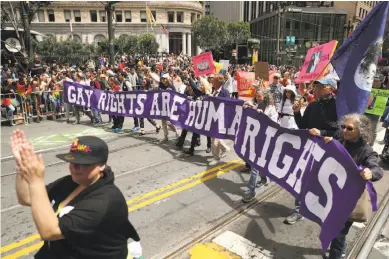  ?? Scott Strazzante / The Chronicle ?? Above: The Resistance Contingent marches on Market Street during San Francisco Pride, which placed a greater emphasis on politics this year.