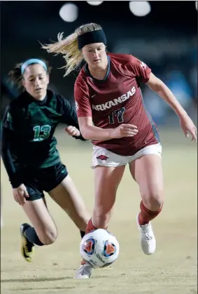  ?? NWA Democrat-Gazette/ANDY SHUPE ?? Arkansas’ Stefani Doyle (top photo, right) pushes the ball past North Texas’ Madeline Guderian on Friday during the first half of their first round game of the NCAA women’s soccer tournament at Razorback Field in Fayettevil­le. (Left photo) Arkansas’ Abbi Neece (right) is upended after colliding with North Texas’ Michelle Gonzalez. Visit nwadg.com/photos to see more photograph­s from the match.