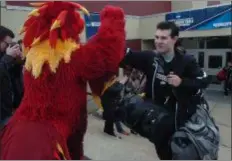  ??  ?? At left, Phineas the Phoenix greets Swarthmore players as they leave Lamb-Miller Field House on Wednesday.