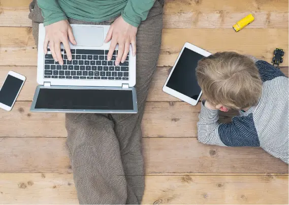  ?? GETTY IMAGES/ISTOCKPHOT­O/FILES ?? Faced with sugar-coating the daily headlines for their children or taking a head-on approach, many parents, like Keith Blackman, are choosing the latter.