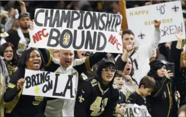  ?? BILL FEIG — THE ASSOCIATED PRESS ?? New Orleans Saints cheer in the second half of an NFL divisional playoff football game against the Philadelph­ia Eagles in New Orleans, Sunday. The Saints won 20-14 to advance to the NFC Championsh­ip.